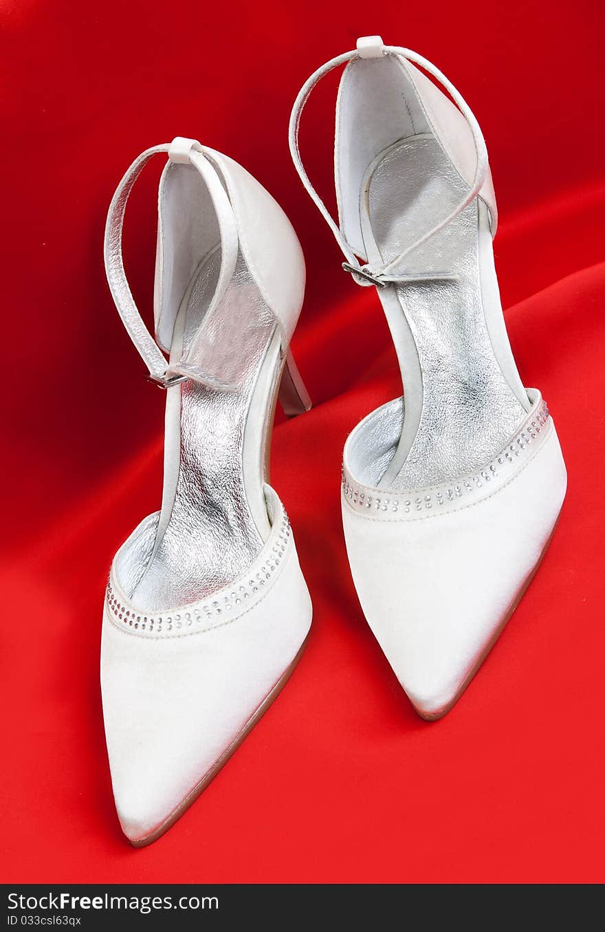 Pair of white women's shoes on a white background