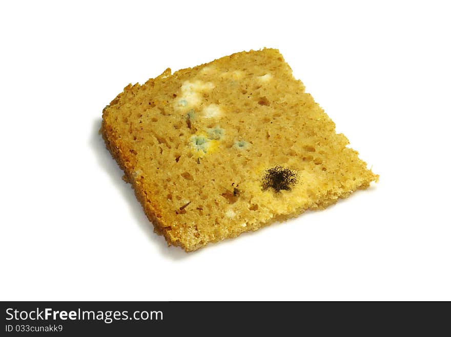 Loaf of mouldy bread against a white background