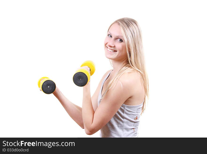 Smiling woman with dumbbells in her hands