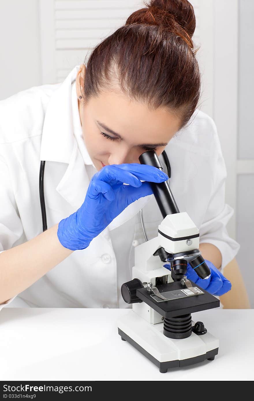 Medical - Female Nurse Looking In Microscope