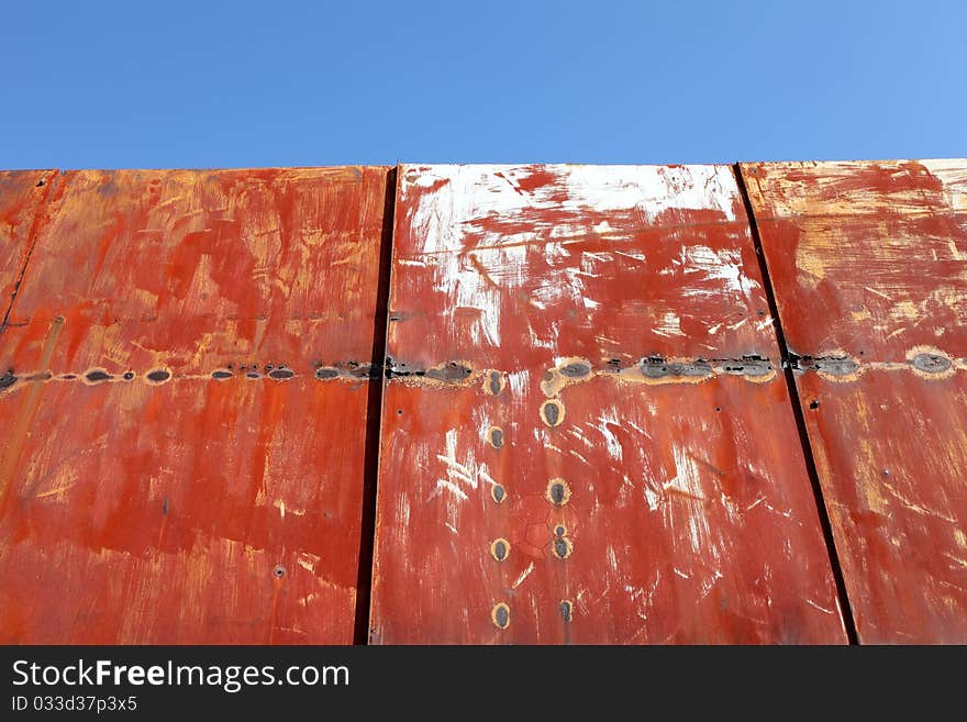 Rusted metal wall and blue sky. Rusted metal wall and blue sky