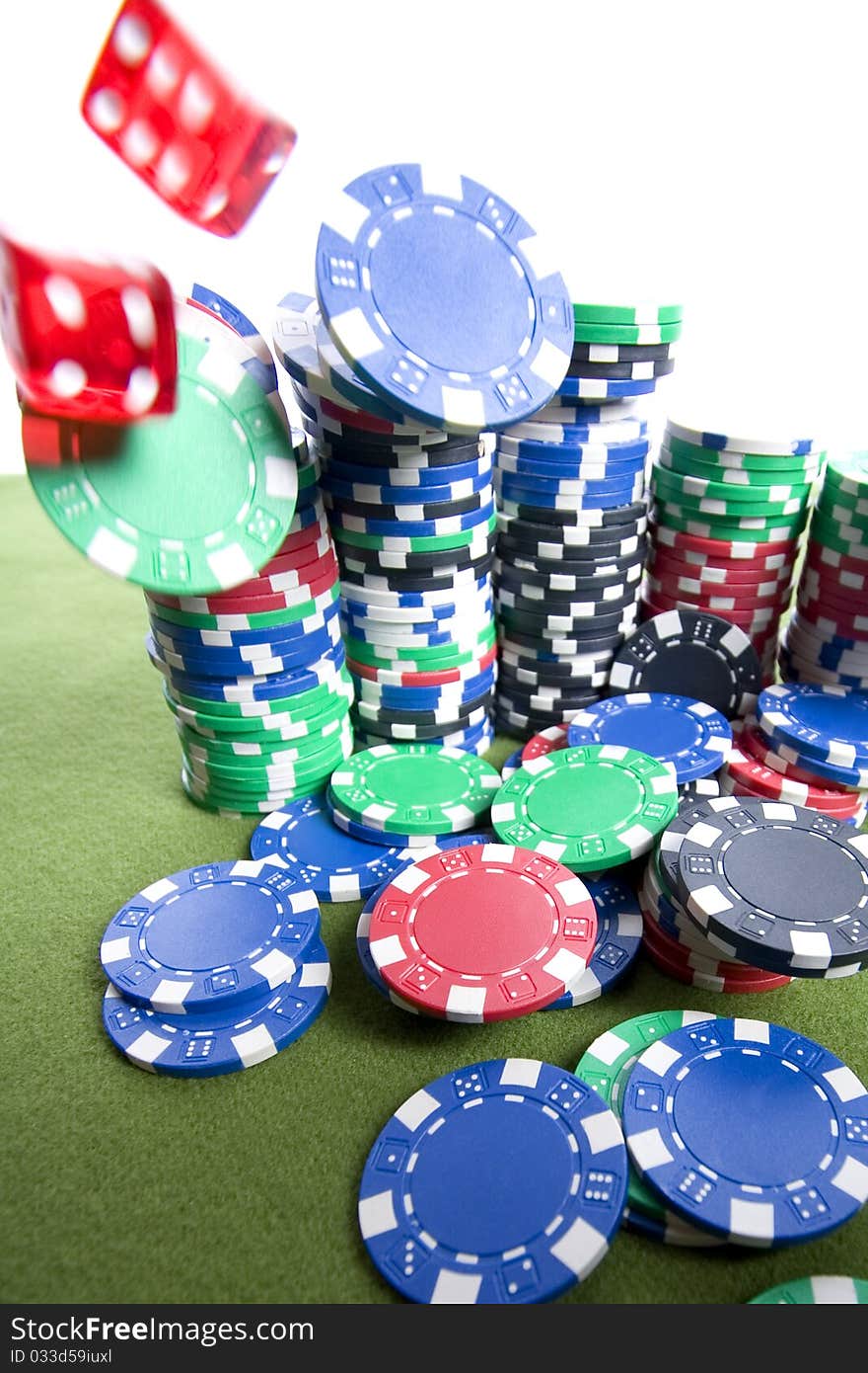 Red casino dice falling on a pile of poker chips