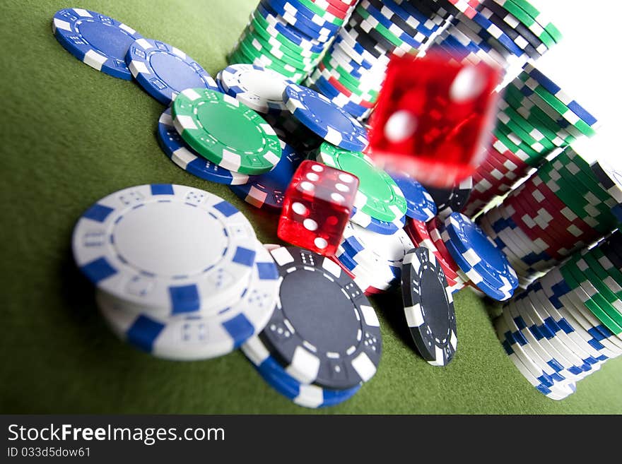 Red casino dice falling on a pile of poker chips