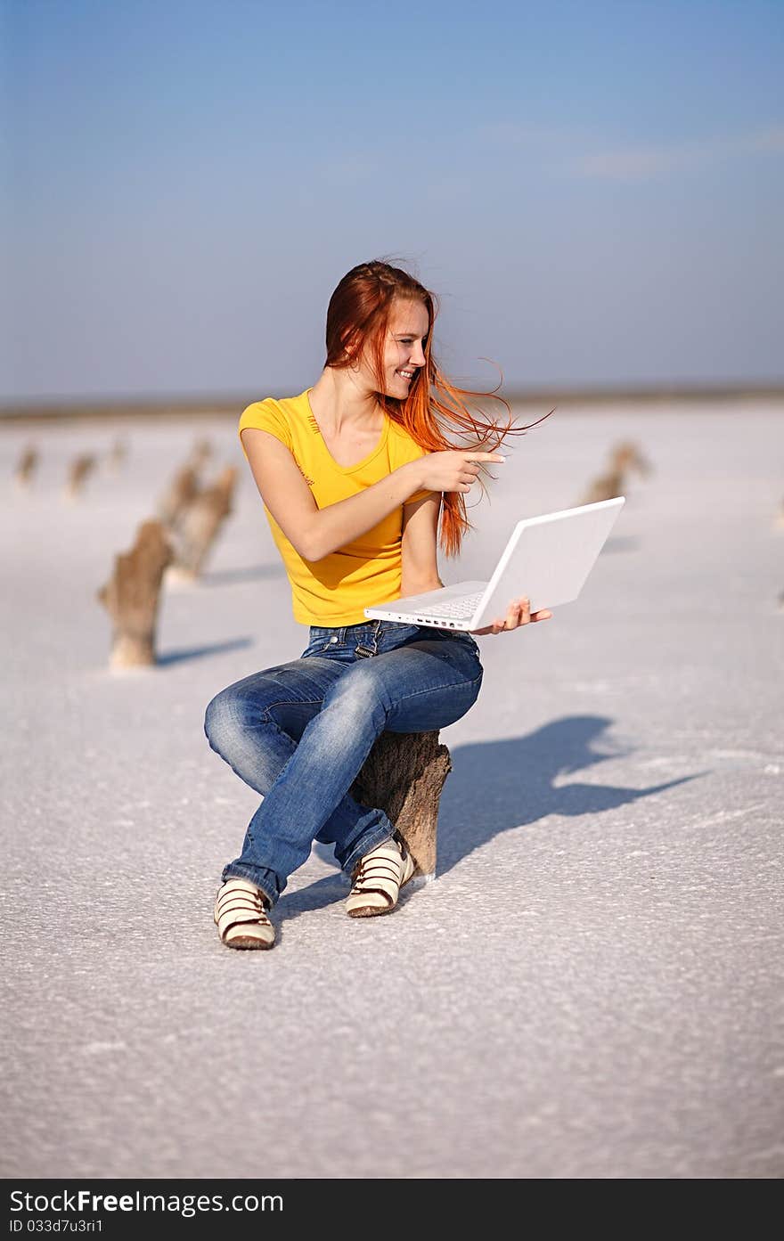 Girl with notebook on the sand