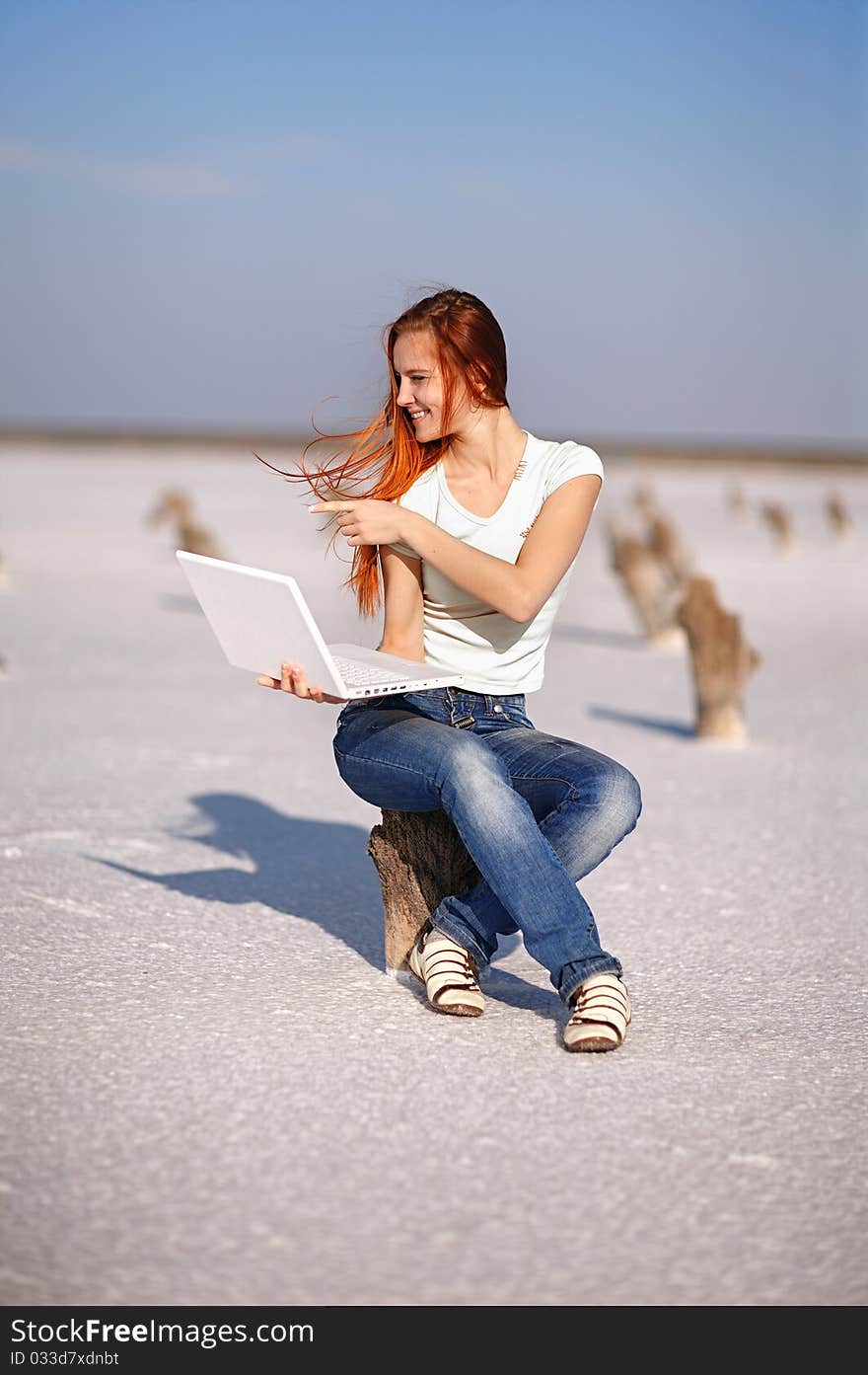 Girl with notebook on the sand