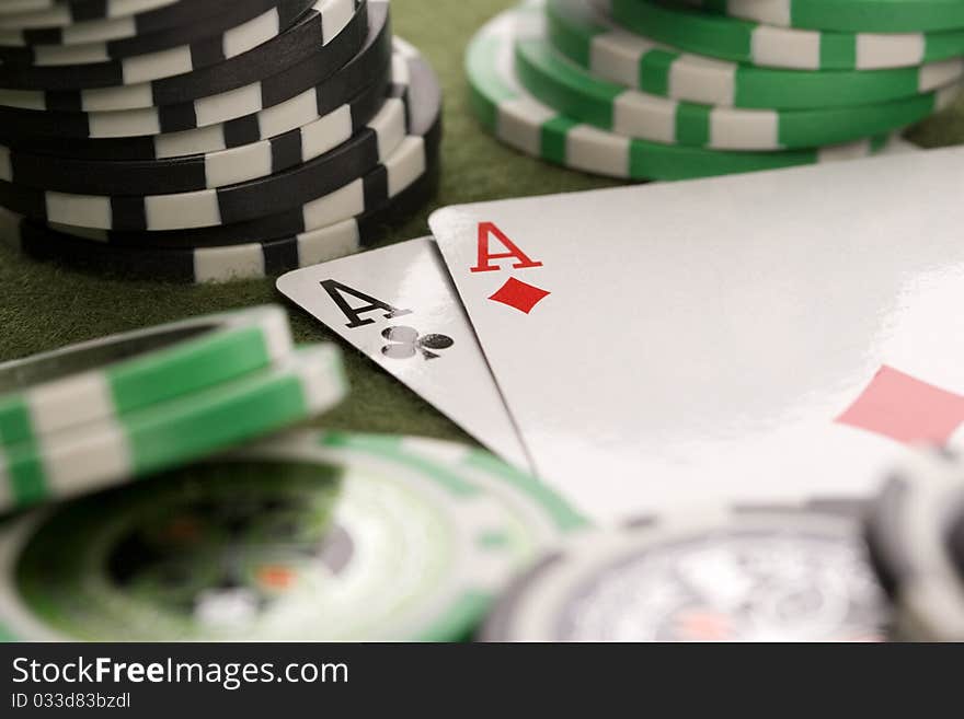 Close-up of Poker cards and gambling chips on green background