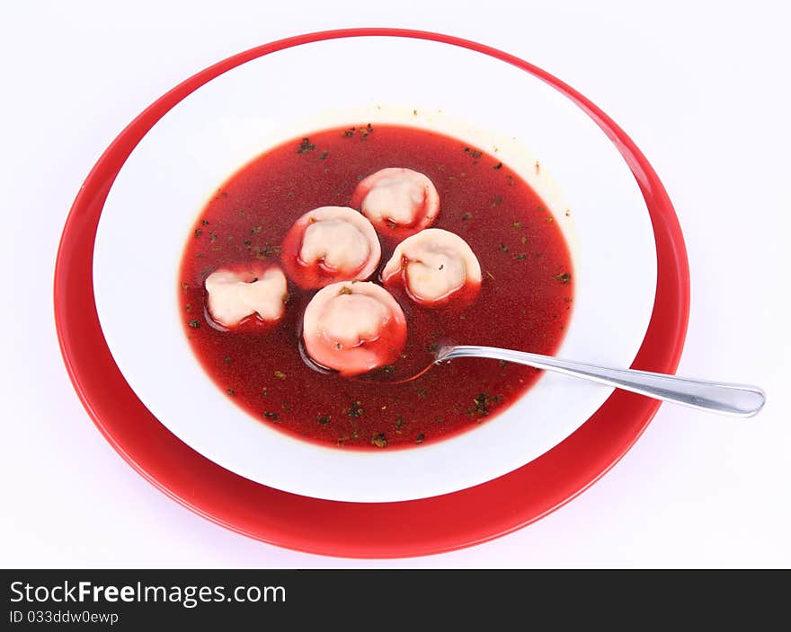 Traditional polish Christmas Eve dish: clear borscht with uszka (a mushroom filled kind of dumplings) , being eaten with a spoon. Traditional polish Christmas Eve dish: clear borscht with uszka (a mushroom filled kind of dumplings) , being eaten with a spoon