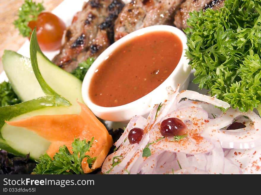 Fried meat served with tomato sauce and salad