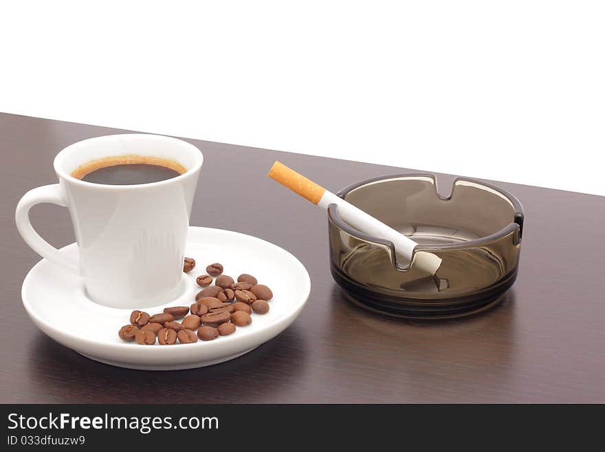 Coffee and a cigarette in an ashtray. Coffee and a cigarette in an ashtray