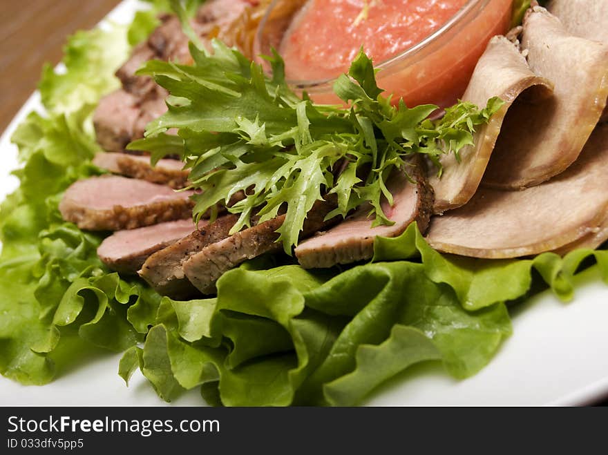 Appetizer made of  meat delicacies and salad. Appetizer made of  meat delicacies and salad