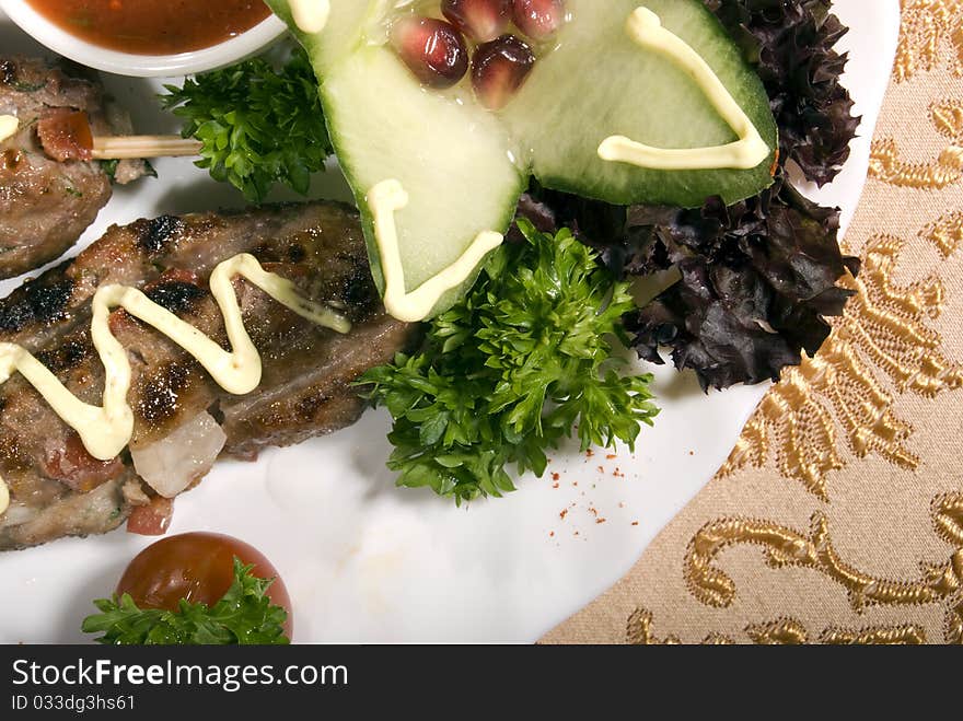 Fried meat served with tomato  and salad