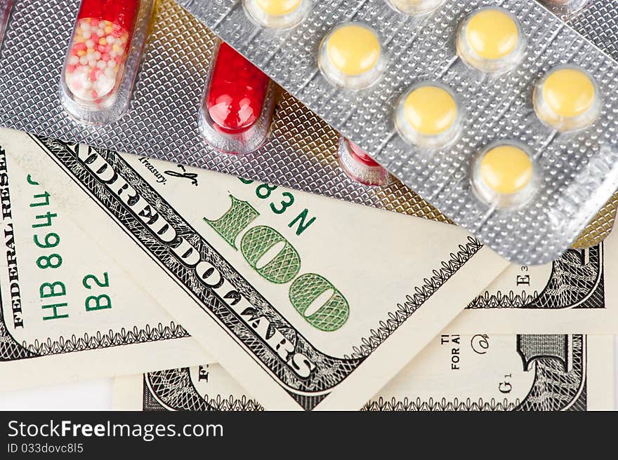 Closeup pills and money, abstract business medical background