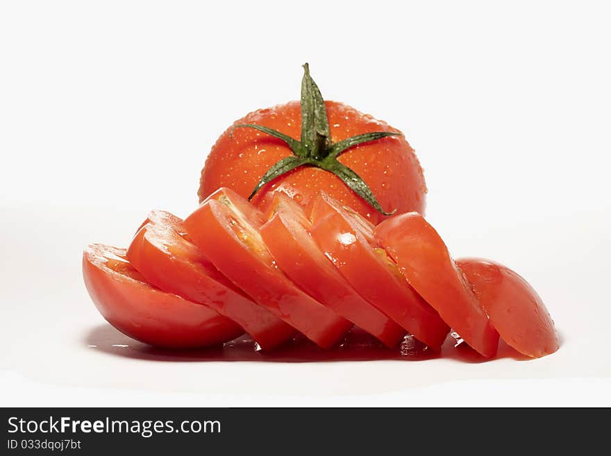 Close view detail of a bunch of red tomatoes isolated on a white background.