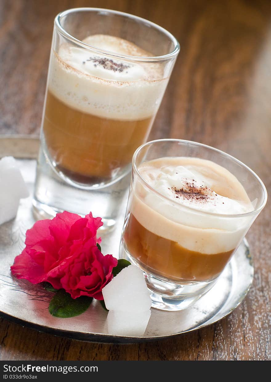 Cafe Latte in glass with spoon on plate. Cafe Latte in glass with spoon on plate