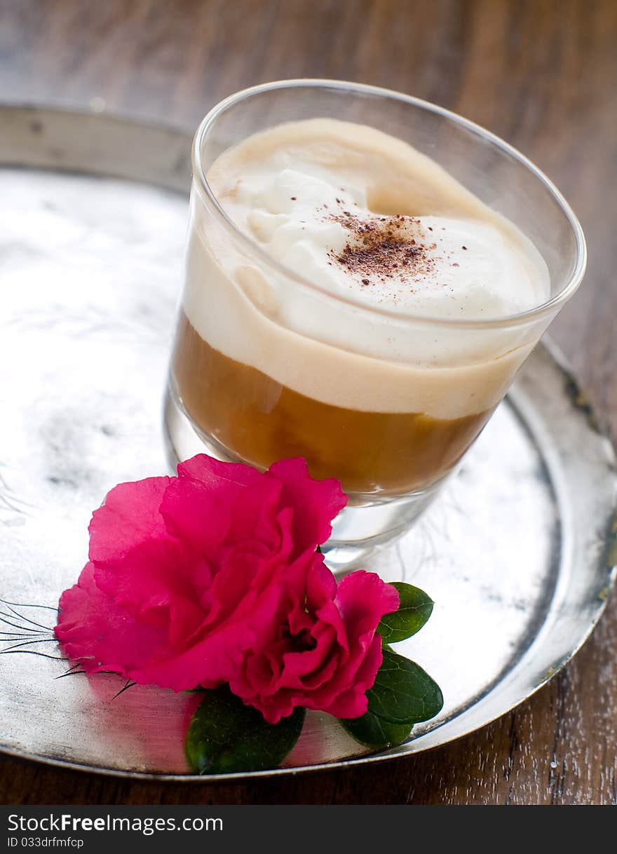 Cafe Latte in glass with spoon  on plate. Cafe Latte in glass with spoon  on plate