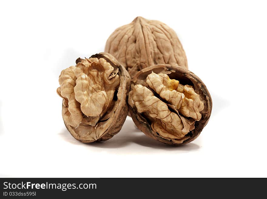 Close view detail of  some walnuts  isolated on a white background. Close view detail of  some walnuts  isolated on a white background.