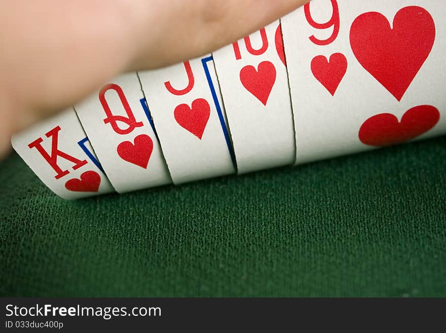 Close-up of Poker cards and gambling chips on green background