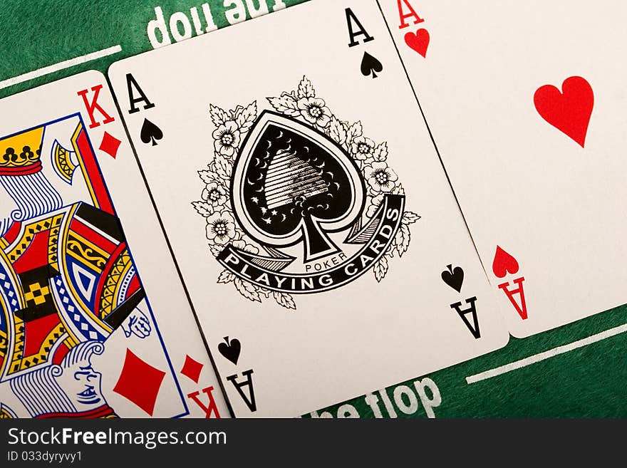 Close-up of Poker cards and gambling chips on green background