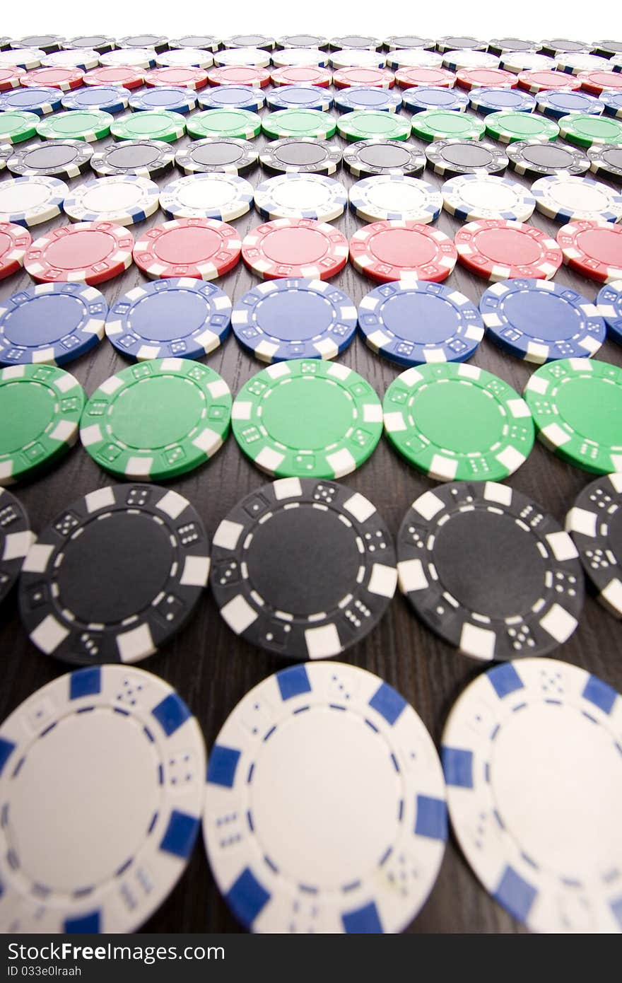 Multi - colored gambling chips on a background. Multi - colored gambling chips on a background