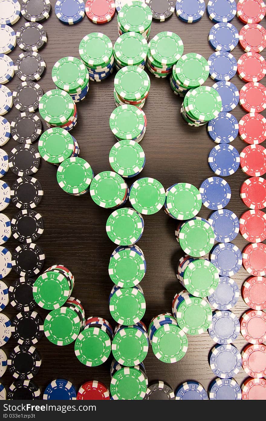 Multi - colored gambling chips and US dollar sign on a background. Multi - colored gambling chips and US dollar sign on a background