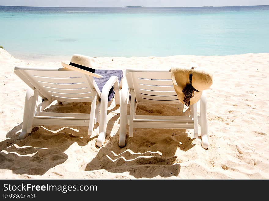 Two Sun Loungers On The Beach