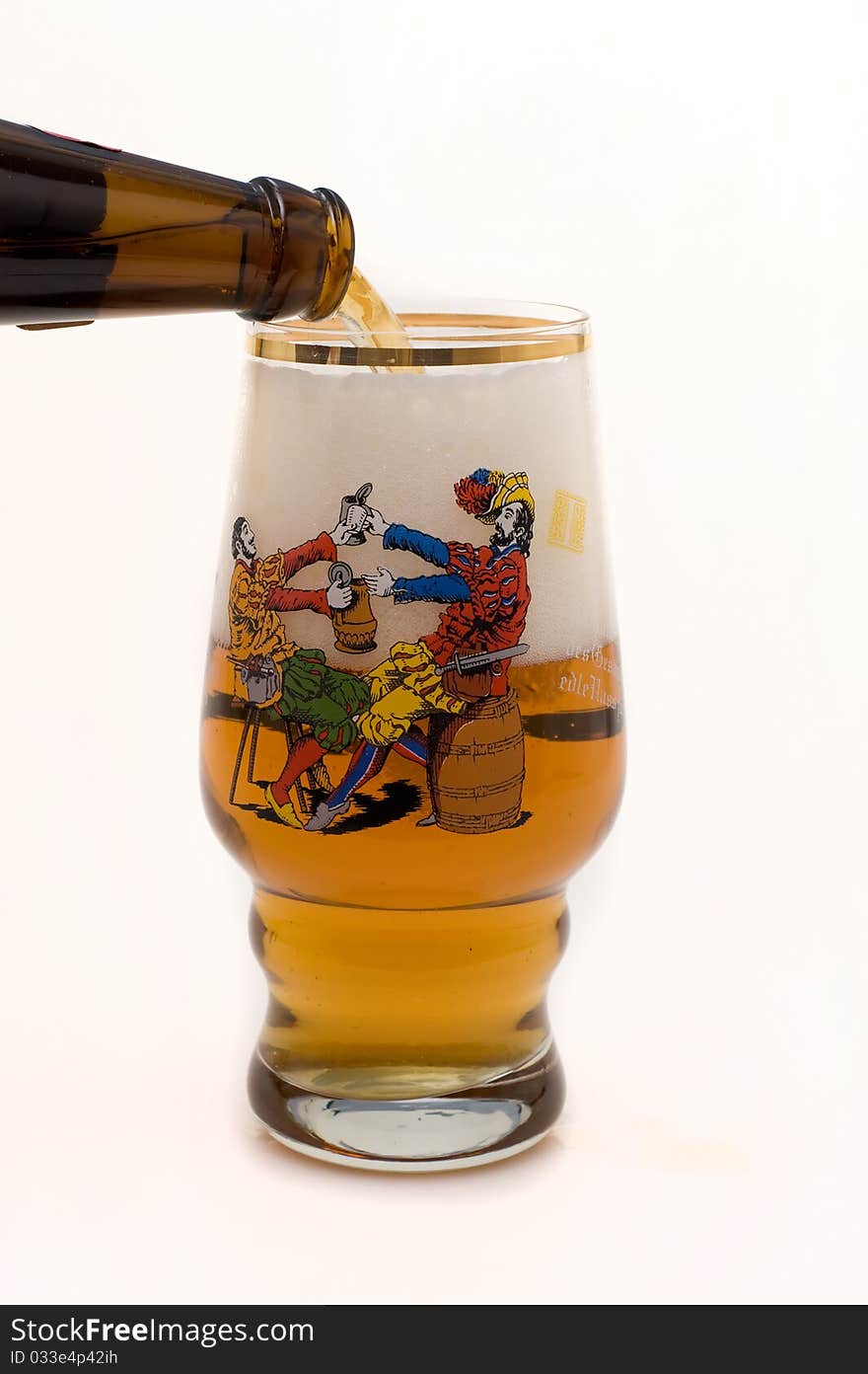 Light foamy beer is poured out of the bottle in glass on a white background