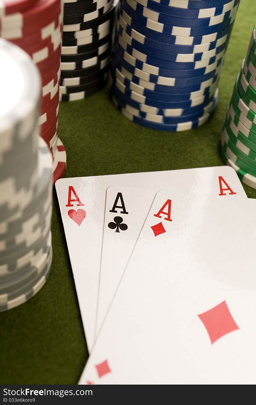 Close-up of Poker cards and gambling chips on green background