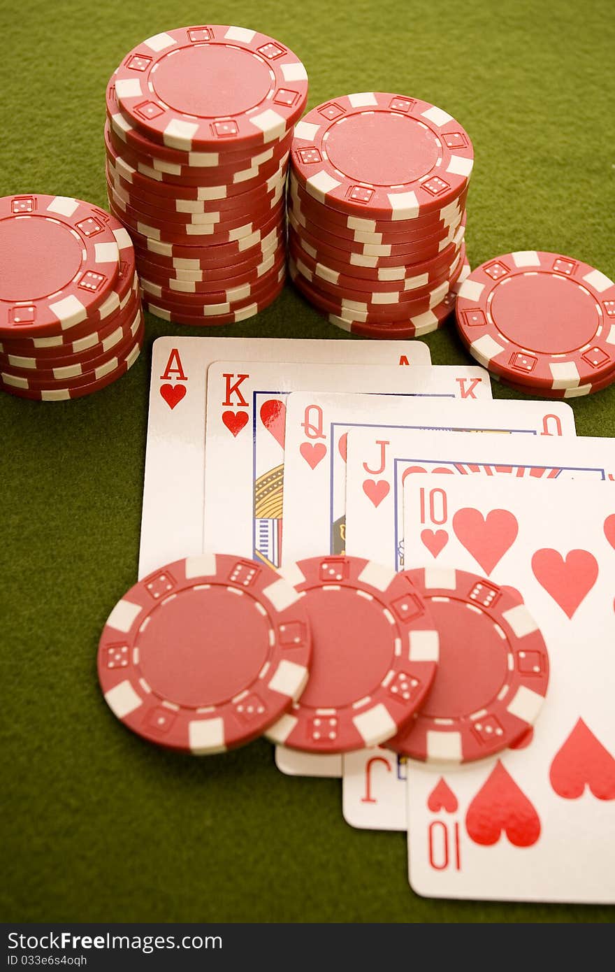 Close-up of Poker cards and gambling chips on green background