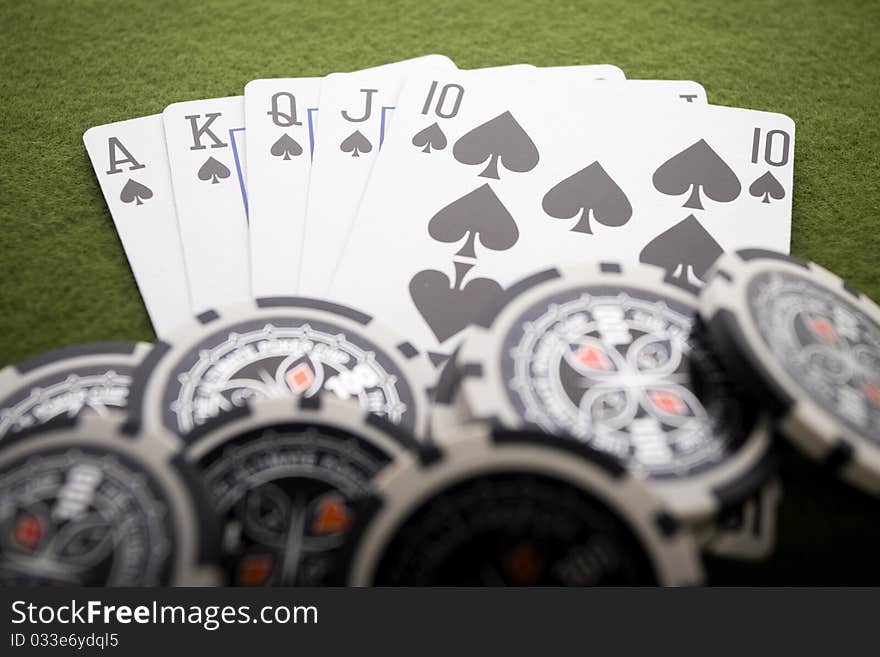 Close-up of Poker cards and gambling chips on green background