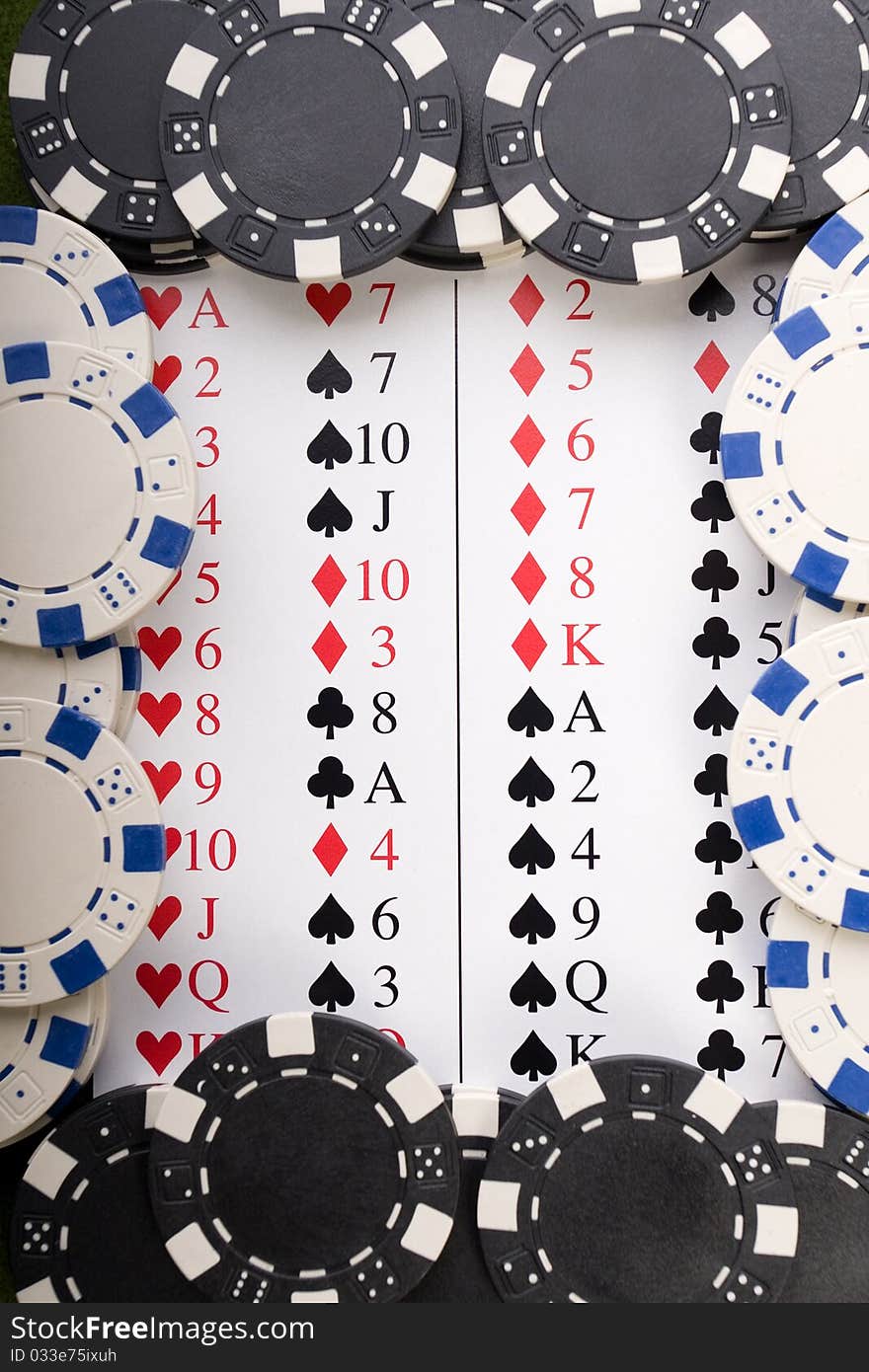 Close-up of Poker cards and gambling chips on green background