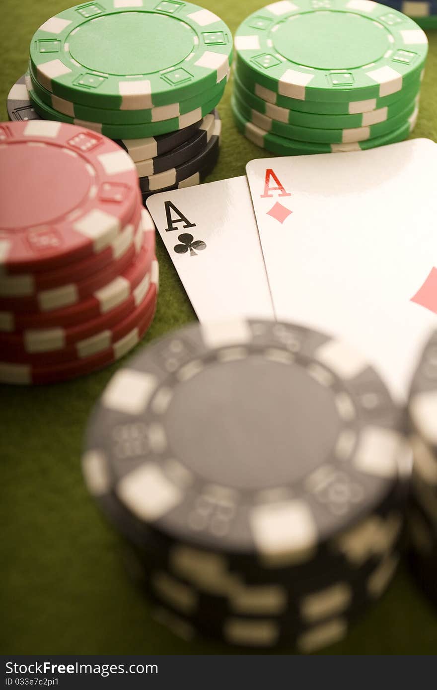 Close-up of Poker cards and gambling chips on green background. Close-up of Poker cards and gambling chips on green background