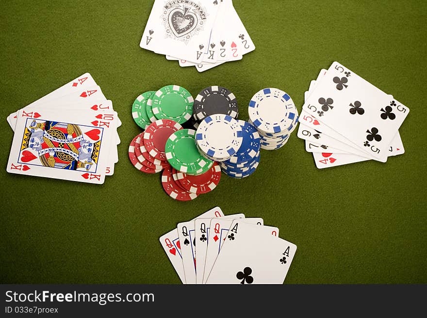 Close-up of Poker cards and gambling chips on green background. Close-up of Poker cards and gambling chips on green background