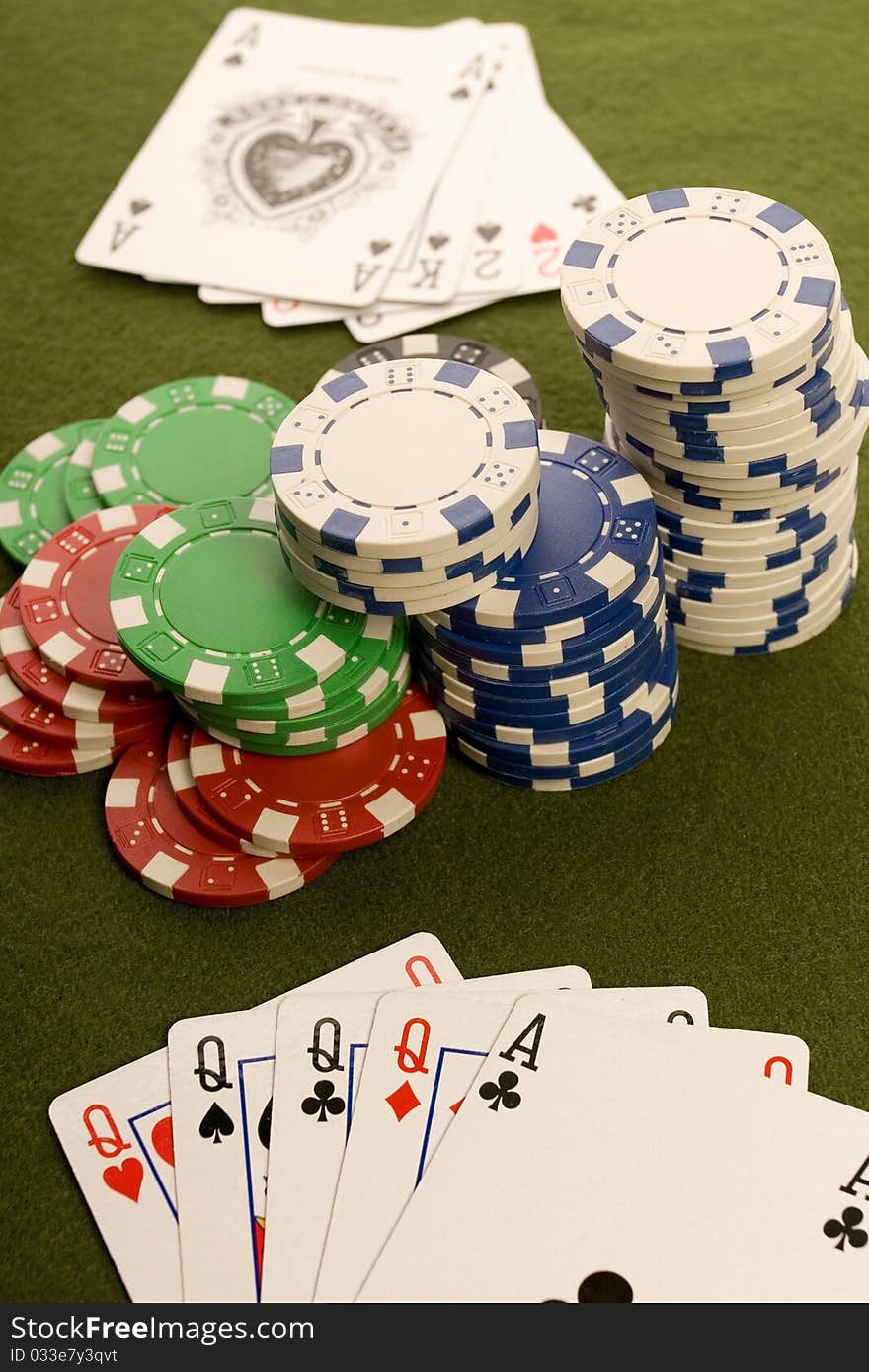 Close-up of Poker cards and gambling chips on green background. Close-up of Poker cards and gambling chips on green background