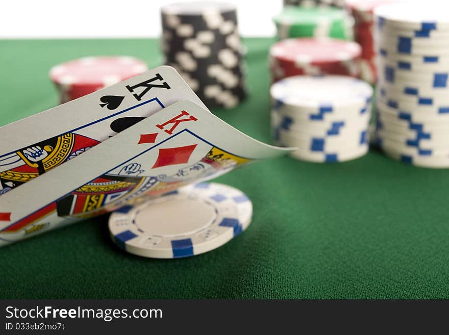 Close-up of Poker cards and gambling chips on green background. Close-up of Poker cards and gambling chips on green background