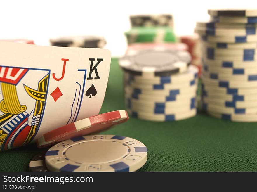 Close-up of Poker cards and gambling chips on green background. Close-up of Poker cards and gambling chips on green background