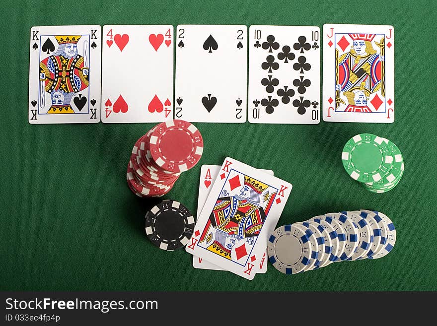 Close-up of Poker cards and gambling chips on green background. Close-up of Poker cards and gambling chips on green background