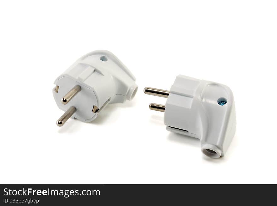 Two white plugs are isolated on a white background