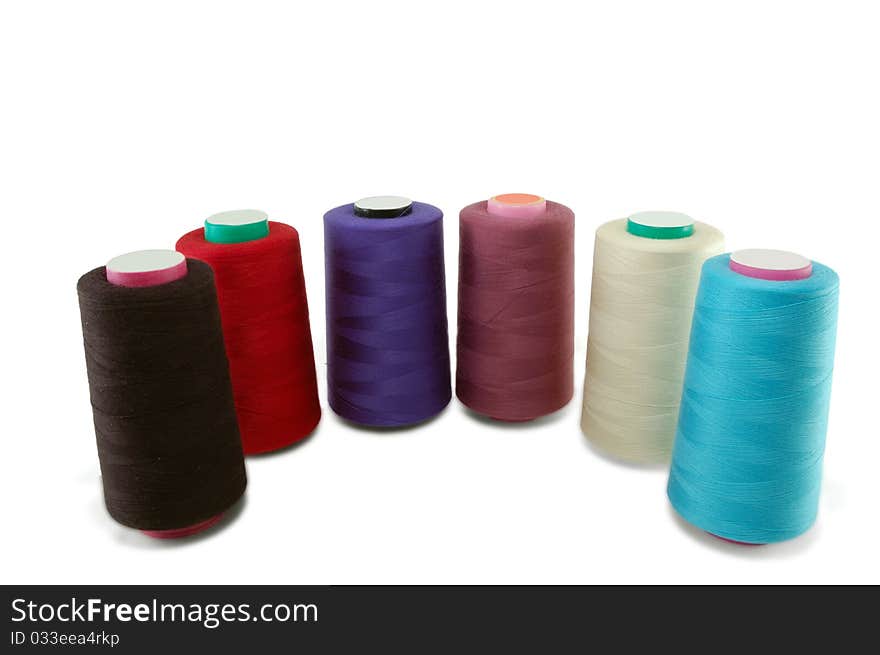 Coils of sewing threads are isolated on a white background