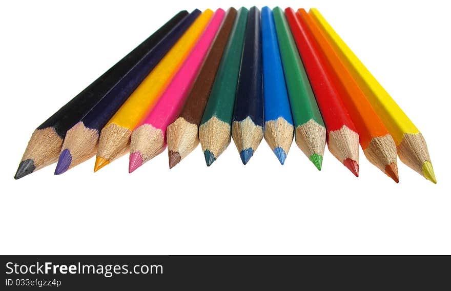 Colourful crayons in the row isolated over white background