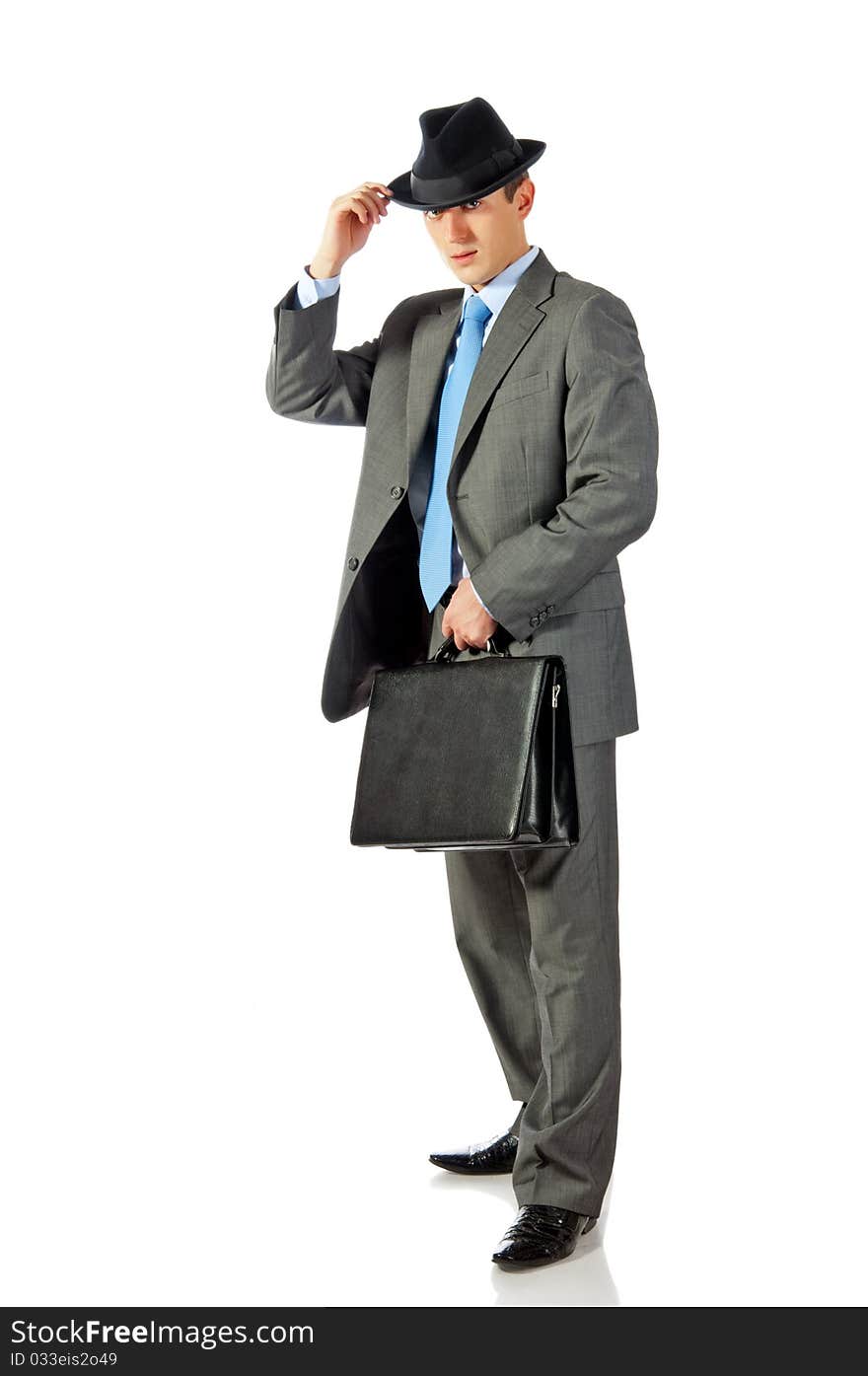 Young Businessman In Hat With Briefcase In Hand