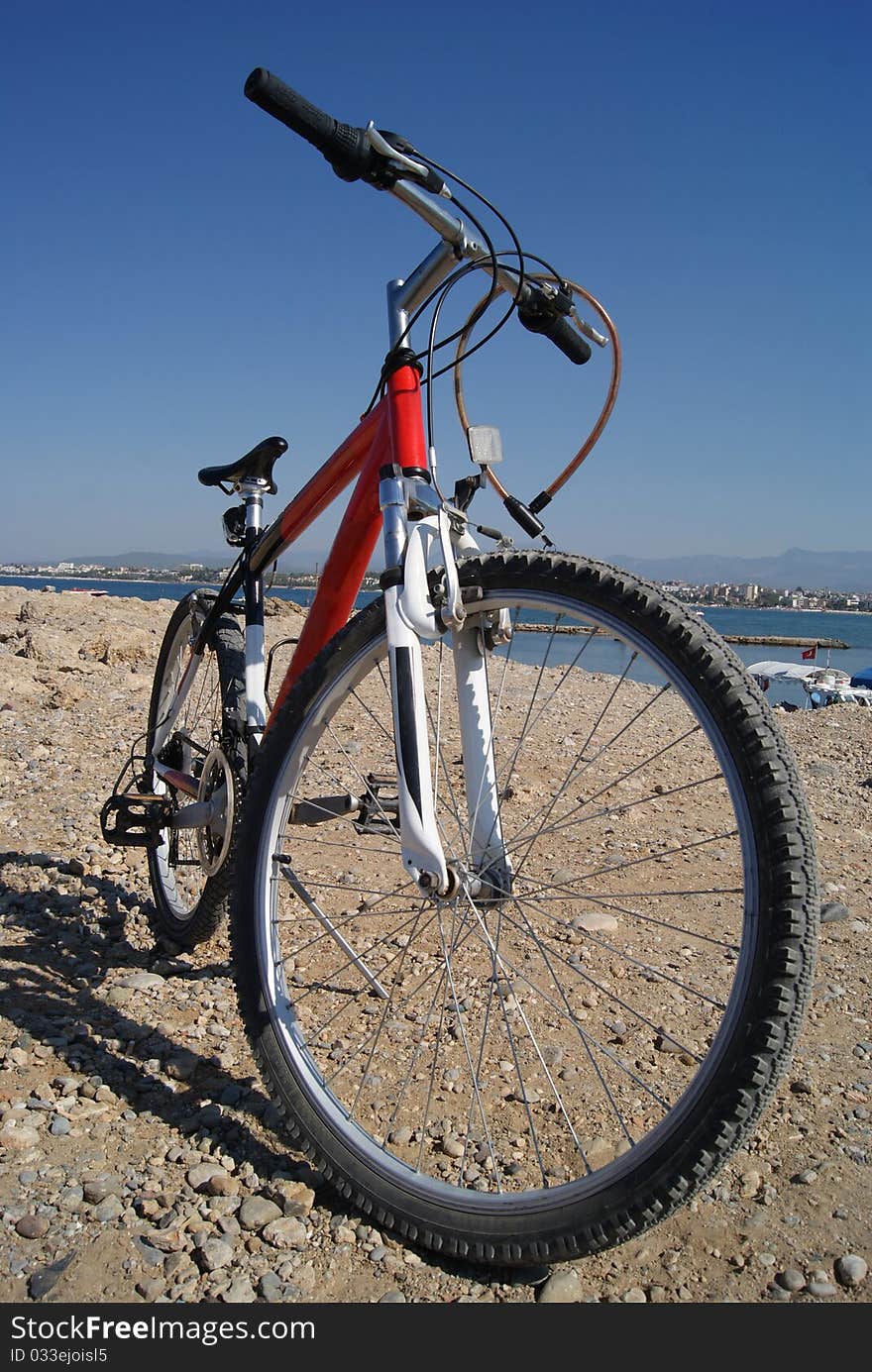 Red bicycle outdoors blue sky sea houses