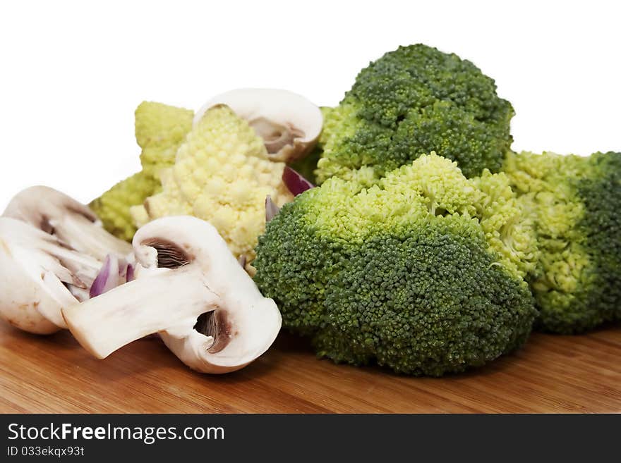 Cauliflower, mushrooms on wooden surface