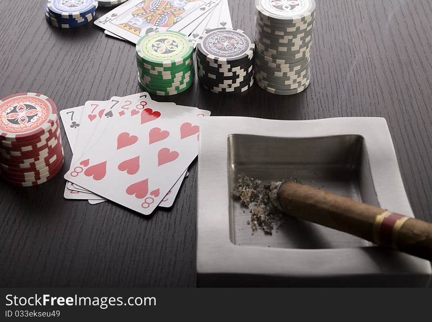 Close-up of Poker cards and gambling chips on green background. Close-up of Poker cards and gambling chips on green background