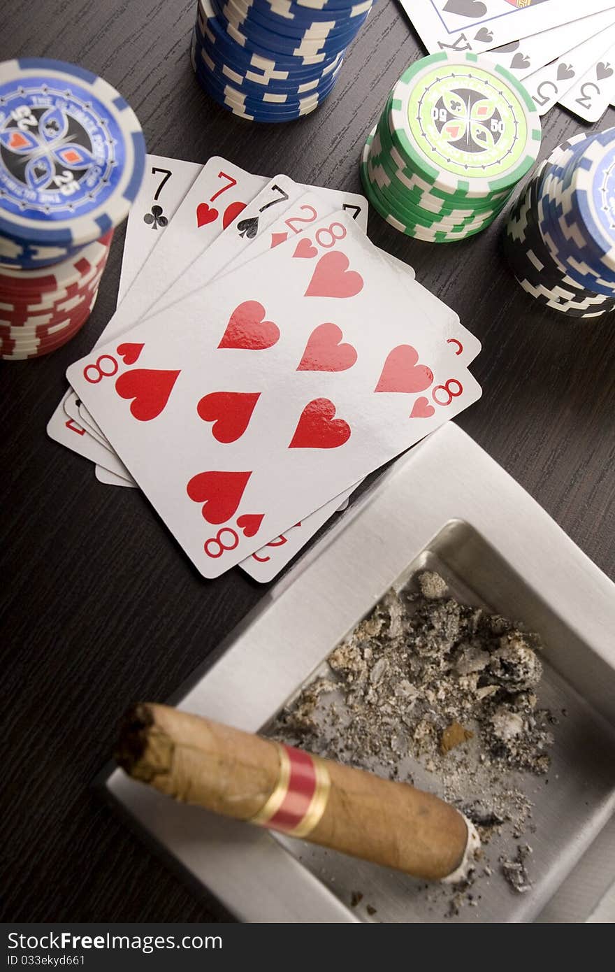 Close-up of Poker cards and gambling chips on green background. Close-up of Poker cards and gambling chips on green background