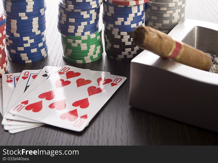 Close-up of Poker cards and gambling chips on green background. Close-up of Poker cards and gambling chips on green background