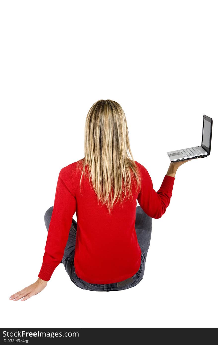 Happy working woman sitting on the floor with her  laptop