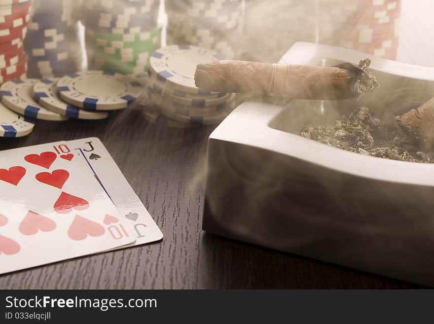 Close-up of Poker cards and gambling chips on green background. Close-up of Poker cards and gambling chips on green background