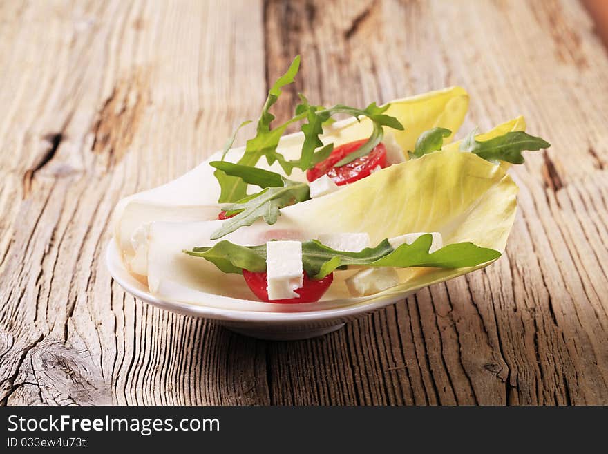 Endive leaves, arugula and diced feta cheese. Endive leaves, arugula and diced feta cheese