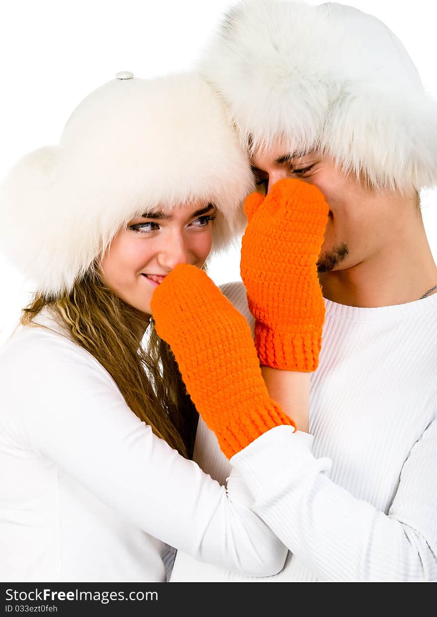 Winter happy lovers are wearing in the  fur hats and orange mittens