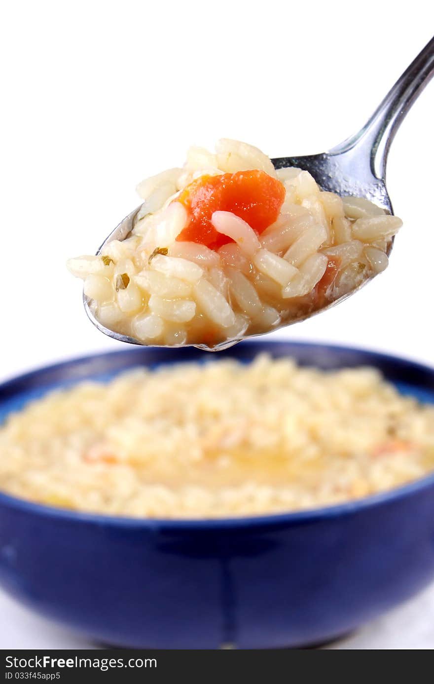 Spoon of rice with chicken and carrots